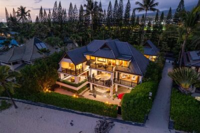 Twilight exterior of oceanfront luxury residence in Kona Bay Estates”